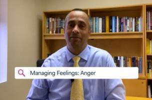 Dr. Simon Rego, Montefiore's Chief Psychologist, sitting in an office discussing feelings of anger toward COVID-19.